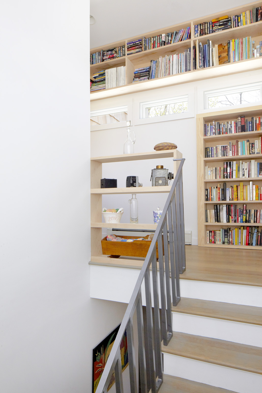 The stair tower's integrated shelving help to contain some of the owner's large 