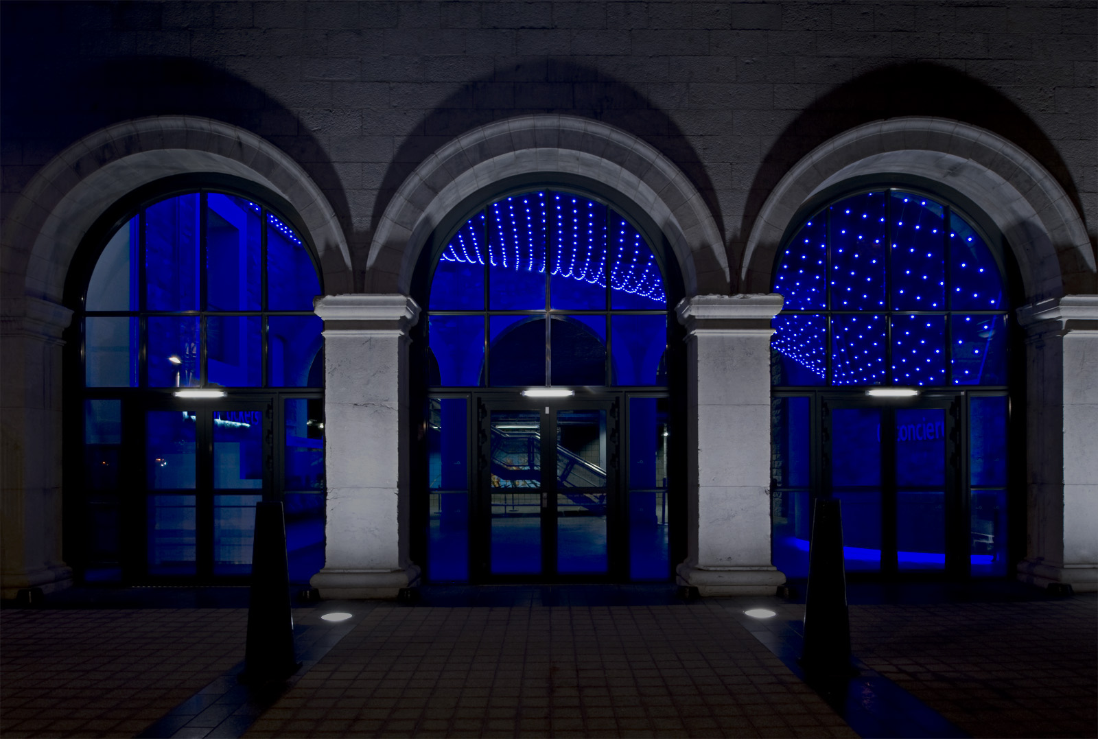 The lighting installation swoops down to the concierge customer service desk