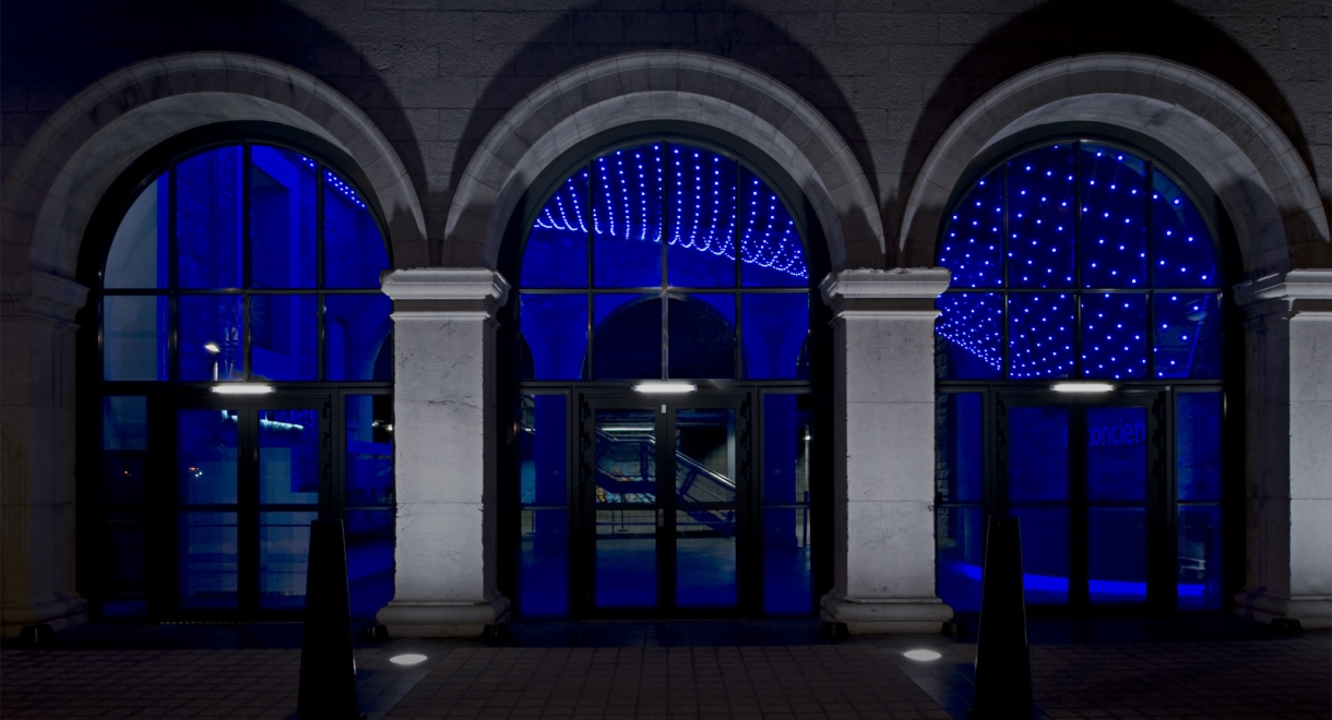 The lighting installation swoops down to the concierge customer service desk